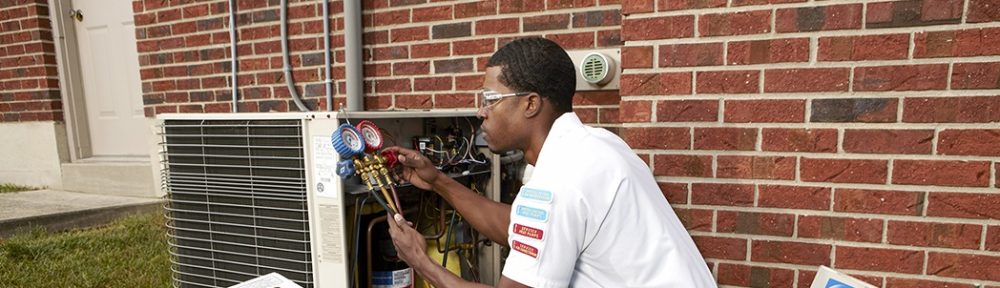 HVAC technician checking for refrigerant leak