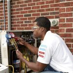 HVAC technician checking for refrigerant leak