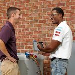 HVAC technician showing customer the results
