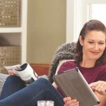 happy couple looking at their electric bill online