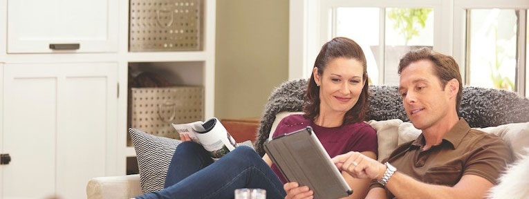 happy couple looking at their electric bill online