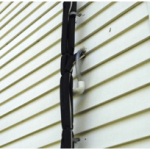 A close up photo of the house above, showing the external refrigerant lines and a condensate drain line. 