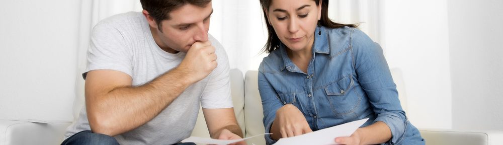 Couple looking over paperwork on how they can save money on their energy bill
