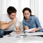 Couple looking over paperwork on how they can save money on their energy bill