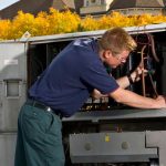 HVAC technician working on HVAC system