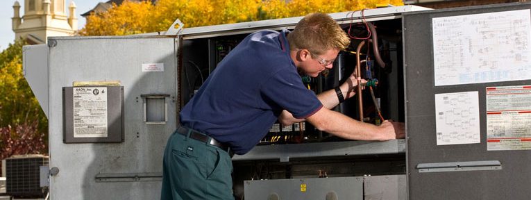 HVAC technician working on HVAC system