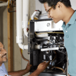 HVAC technician smiling at happy customer while working on an HVAC system