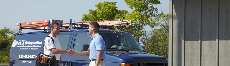 HVAC technician greeting customer